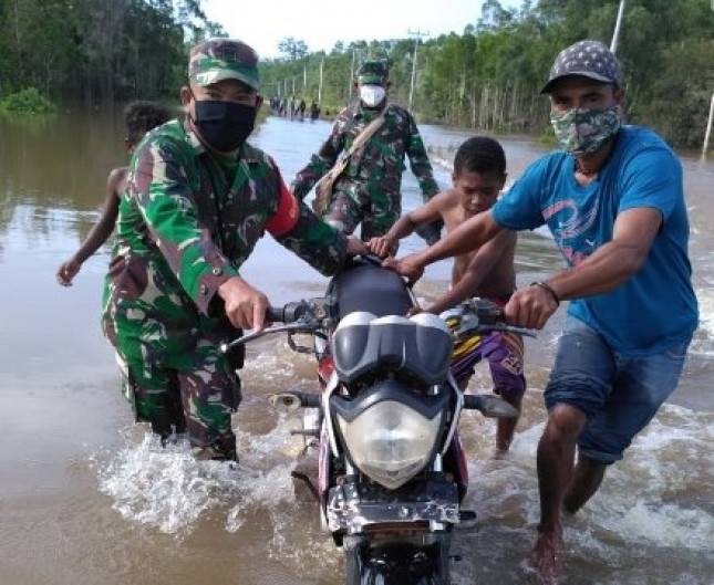 Prajurit TNI-Polri Bantu Pengendara Motor Tersebak Banjir Trans Papua